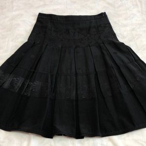 Black pleated skater skirt with brocade accents